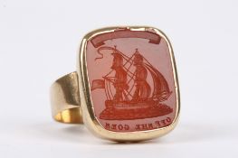 An unusual, large antique carved carnellian intaglio mounted as a ring the intaglio depicting a