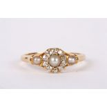 A delicate Victorian pearl and diamond cluster ring the central half pearl set within diamonds and