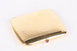 An elegant Art Deco Continental 18ct gold cigarette case of ribbed design having a pink cabochon