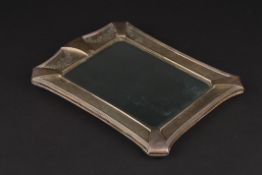 A George V silver easel mirror hallmarked Birmingham 1932, with floral engraved frame and bevelled