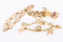 A child's 9ct gold fancy link charm bracelet and related charms including a chick, a rabbit and a
