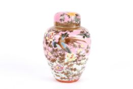 A Japanese porcelain ginger jar decorated with birds and flowers against a pink and white ground,