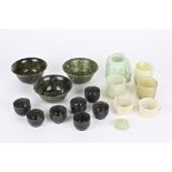 A collection of assorted modern carved Chinese spinach hardstone bowls and cups of various sizes and