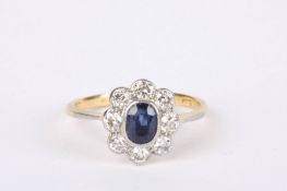 An Art Deco sapphire and diamond set oval cluster ring with central sapphire surrounded by diamonds.