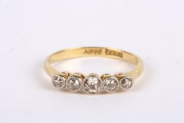 A delicate Edwardian five stone diamond set ring the stones with slight 'cinnamon' tint 18ct gold