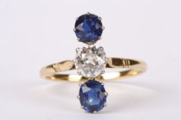 An attractive Edwardian sapphire and diamond three stone ring the central diamond set with single