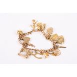 A 9ct gold charm bracelet set with thirteen charms including a sewing machine, scissors and