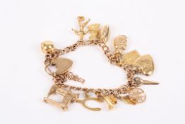 A 9ct gold charm bracelet set with thirteen charms including a sewing machine, scissors and