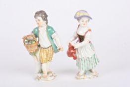 A pair of 20th century Meissen porcelain figures of a gardening boy and girl the boy with a basket