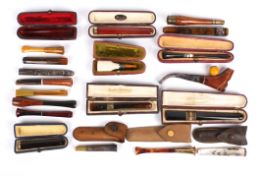 A collection of twenty assorted cigarette holders of various shapes and designs, including ten in