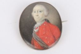 A 19th century portrait miniature of a gentleman painted on ivory, and wearing a red tunic with