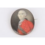 A 19th century portrait miniature of a gentleman painted on ivory, and wearing a red tunic with