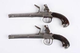 A pair of 19th century flintlock pocket pistols with ring turned barrels, with side plates