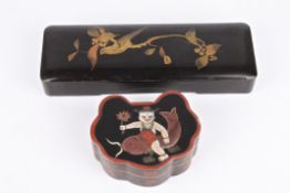 A Japanese black lacquer glove box decorated in gilt with a bird on a branch, together with