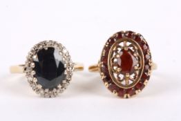A sapphire and diamond oval cluster ring set in 18ct yellow gold, together with a garnet cluster