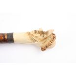 An unusual carved ivory and bone walking stick with triple head the pommel carved with triple