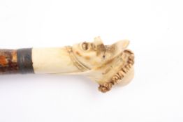 An unusual carved ivory and bone walking stick with triple head the pommel carved with triple