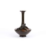 A late 19th Japanese bronze baluster vase decorated with applied leaves with flared neck and bulbous