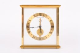 A Jaeger le Coultre inline desk clock with open gilded chapter ring and black Roman numerals, with