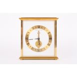 A Jaeger le Coultre inline desk clock with open gilded chapter ring and black Roman numerals, with