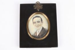 An early 20th century miniature portrait of a gentleman painted on celluloid, in an ebonised frame