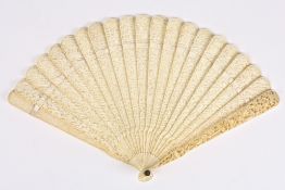 An early 20th century Chinese Canton carved brisé ivory fan finely carved and pierced all over on
