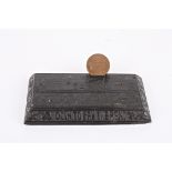 An unusual Irish carved oak coin stand 'Coin to Pay the Rent', carved with a harp, shamrocks and