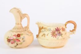 Two Royal Worcester blush ivory jugs, one with slender neck and scrolled handle, the other of