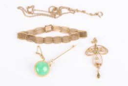 An Art Nouveau pearl and peridot set 15ct gold mounted stylised scroll pendant on 9ct chain, sold