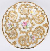 A 20th century Meissen porcelain dish painted with flowers surrounded by rich gilt floral