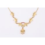 A mid 20th Century gold and ruby floral cocktail necklace the central floral drop set with three