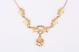 A mid 20th Century gold and ruby floral cocktail necklace the central floral drop set with three