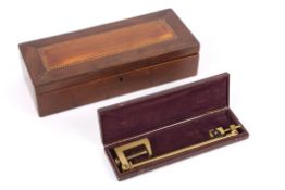 An early 20th century brass camera lucida in a fitted case, together with a yew wood inlaid glove