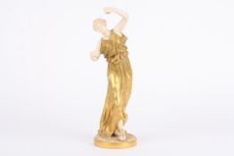 A large Royal Worcester gilt decorated figure of a classical woman in a long flowing robe holding