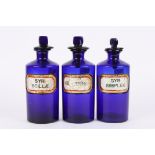 A set of three 19th century Bristol blue glass apothecary jars with inset glass labels 'SYR: