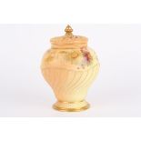 A Royal Worcester blush ivory potpourri vase and cover of wrythen form and decorated with flowers,