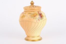 A Royal Worcester blush ivory potpourri vase and cover of wrythen form and decorated with flowers,