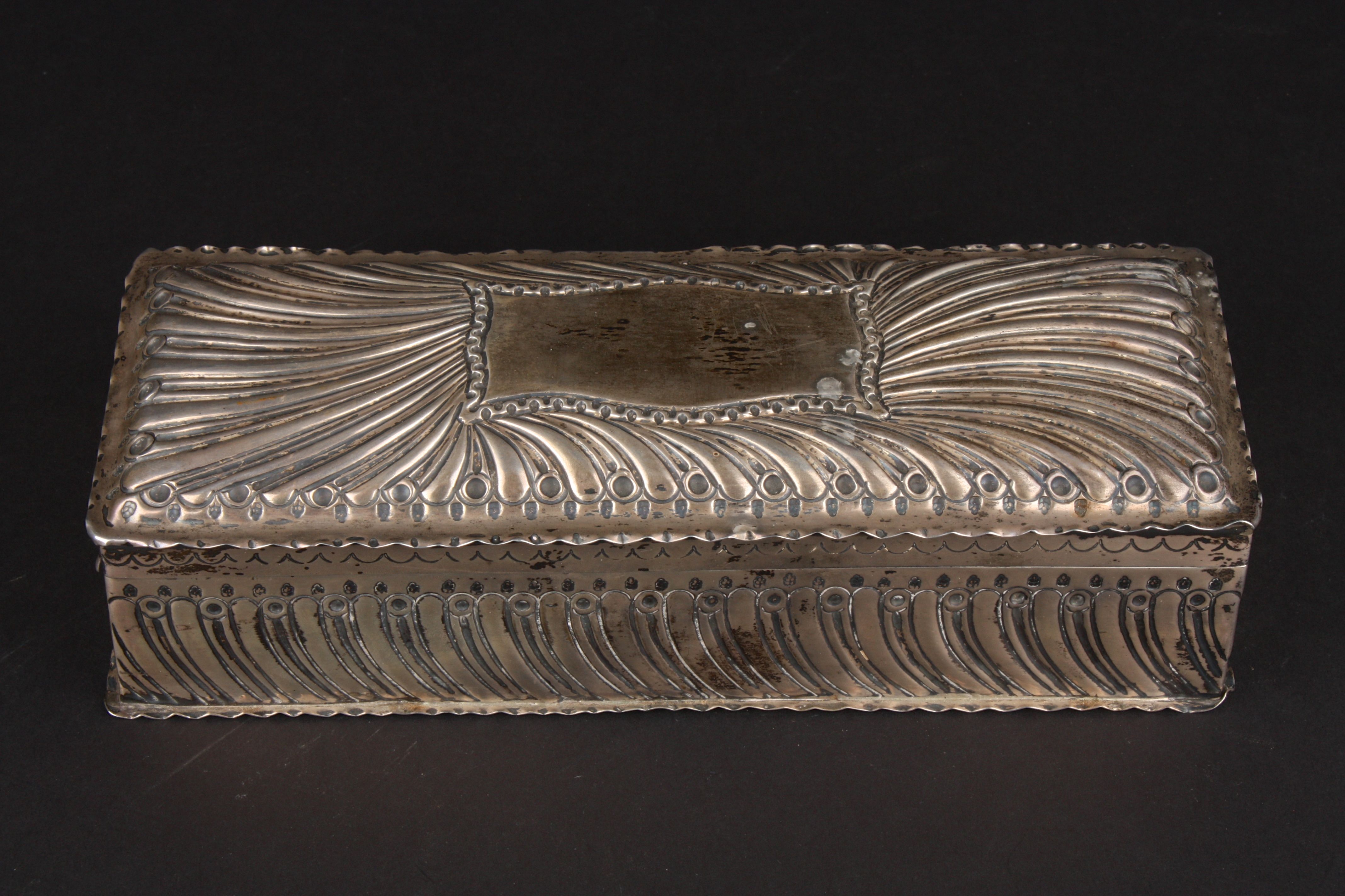 A large Victorian silver repoussé glove box hallmarked London 1885, of fluted design with large