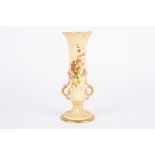 A large Royal Worcester blush ivory spill vase with twin scrolled handles and decorated with