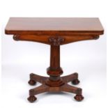 A Victorian rosewood foldover card table the figured top opening to reveal a green baize interior,