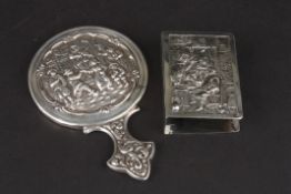 A small Dutch silver repoussé pocket hand mirror decorated with a scene of figures merrymaking,