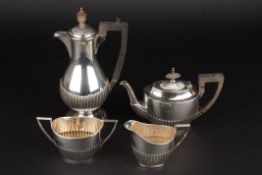 A Walker & Hall four piece silver harlequin bachelors tea set hallmarked Sheffield 1911 and 1920