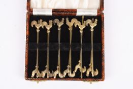 A set of 12 silver gilt cocktail sticks crested with cockerels, in a fitted case. Condition: