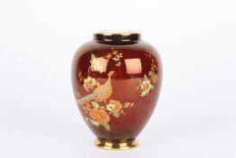 A Carlton Ware Rouge Royale ovoid vase decorated in gilt with a pheasant and foliage on a red lustre