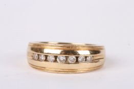 A Liberty & Co. diamond ring the 14ct gold mount with a central line of seven small channel set