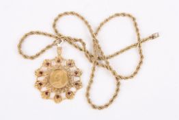 A Victorian 1890 22ct gold full sovereign pendant set in 9ct gold and surrounded by garnets,