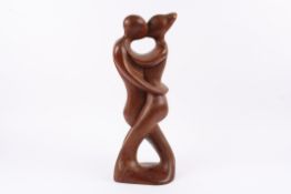 A large carved tribal hardwood figural sculpture signed J. Tamayo 99 of two figures embracing,