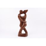 A large carved tribal hardwood figural sculpture signed J. Tamayo 99 of two figures embracing,