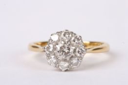 A diamond set circular cluster ring, the centre stone approx. 0.20ct and surrounded by smaller