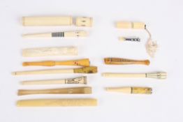 A collection of eleven 1920s ivory and faux ivory cigarette holders of various shapes and designs.